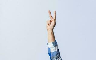 Hand gesturing the letter K in sign language on an isolated background. Man's hand gesturing the letter K of the alphabet isolated. Letters of the alphabet in sign language photo