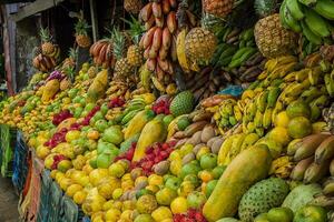 Shelf of many fresh fruits, fresh fruit stall, concept of fruits and healthy food, sale of various fruits photo