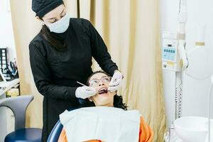 Dentist performing dental checkup, Patient checked by dentist, close up of dentist with patient, dentist performing root canal treatment on patient photo