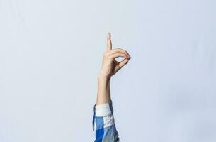 Hand gesturing the letter D in sign language on isolated background. Man hand gesturing the letter D of the alphabet isolated. Letters of the alphabet in sign language photo