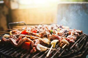 Charcoal roasted meat skewers. Homemade roast meat skewers on charcoal grill. Top view of meat roasted on a grill photo