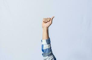 Hand gesturing the letter A in sign language on isolated background. Man hand gesturing the letter A of the alphabet isolated. Letters of the alphabet in sign language. photo