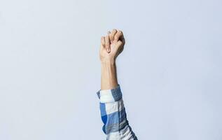 Hand gesturing the letter N in sign language on an isolated background. Man's hand gesturing the letter N of the alphabet isolated. Letter N of the alphabet in sign language photo