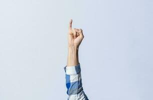 Hand gesturing the letter I in sign language on an isolated background. Man's hand gesturing the letter I of the alphabet isolated. Letters of the alphabet in sign language photo