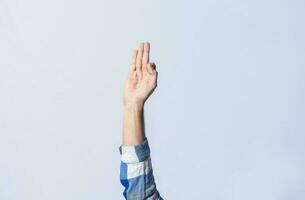 Hand gesturing the letter F in sign language on isolated background. Man hand gesturing the letter F of the alphabet isolated. Letters of the alphabet in sign language photo