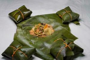 Top View of raw ingredients of the Nicaraguan nacatamal on banana leaves. Raw ingredients for the preparation of the traditional Nacatamal, Nacatamal ingredients on banana leaves photo