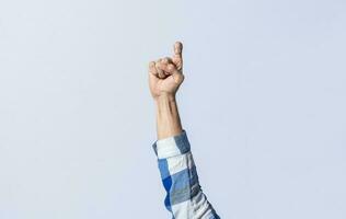Hand gesturing the letter Z in sign language on an isolated background. Man's hand gesturing the letter Z of the alphabet isolated. Letter Z of the alphabet in sign language photo
