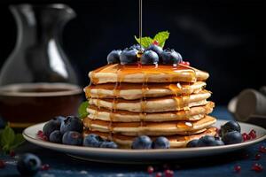 Delicious pancakes, with fresh blueberries and maple syrup flows from a stack of pancake photo