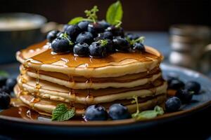 Delicious pancakes, with fresh blueberries and maple syrup flows from a stack of pancake photo