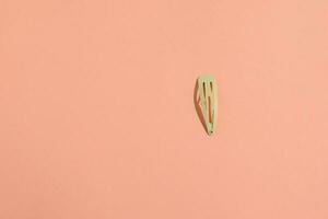 Hair pin, hairstyle accessories on peach background photo