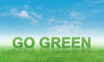 Go Green on grass field against blue sky background. ecology concept photo