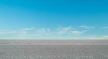 Empty asphalt road over blue sky cloud background photo