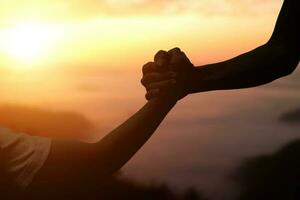 Giving a help hand concept. Reaching hand helping, hope and support each other over sunset background. photo