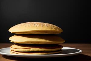 A Stack Of Pancakes Sitting On Top Of A White Plate. AI Generated photo