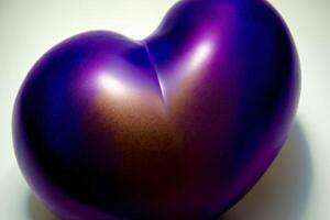 A Shiny Purple Heart Shaped Object On A White Surface. photo