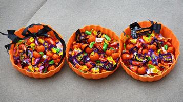 A Couple Of Orange Bowls Filled With Candy. AI Generated photo