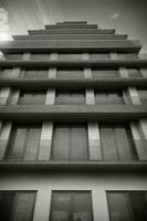 A Black And White Photo Of A Tall Building. AI Generated