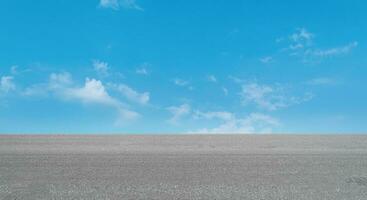 Empty asphalt road over blue sky cloud background photo