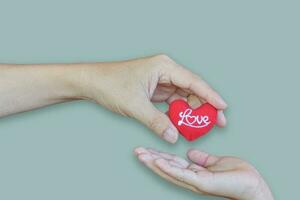 Father giving heart symbol to daughter on blue background. love concept photo