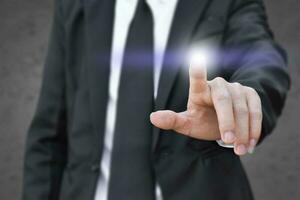 Businessman finger pressing an imaginary screen. Idea for business, technology, internet and networking. photo