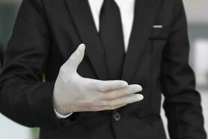 Close up of businessman wearing white latex gloves photo