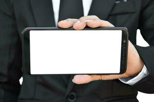 Close up of businessman hold blank screen smartphone in hand, Isolated on white background with clipping path. photo