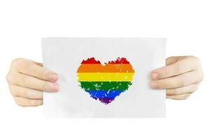 Hands holding paper with heart shape LGBTQ color, Isolated on white. Transgender couple freedom Love concept. photo