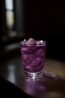 A Purple Drink Sitting On Top Of A Wooden Table. photo