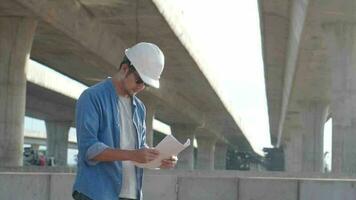 asiatisch bürgerlich Ingenieur ist inspizieren Konstruktion Projekt ein Straße Schnellstraße beim Konstruktion Seite? ˅. video