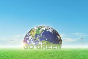 Go green and globe on wind turbine field with blue sky background. Environment and earth day concept. image furnished by NASA photo