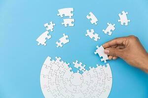 Jigsaw connection, Jigsaw puzzle in the hand of a businessman,  Business team assembling Jigsaw puzzle. photo