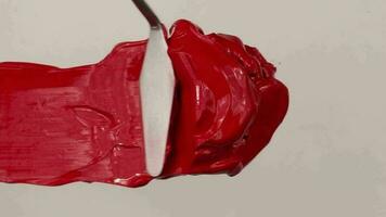 Red acrylic paint with spatula video