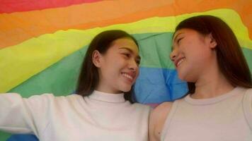 Girlfriends couple love smiling together covered with rainbow equality freedom LGBTQ gay proud pride. video