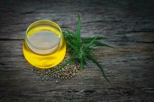 Cannabis herb and leaves with oil extracts in jars. medical concept, marijuana CBD oil hemp products. photo