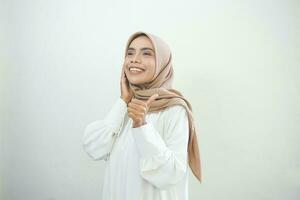 Beautiful smiling Asian woman in white casual showing thumbs up gesture with hand isolated over white background photo