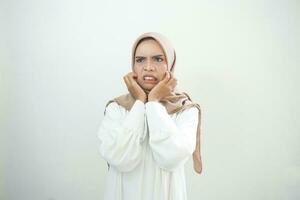 Portrait of young  Asian muslim woman panic and fear on white background photo