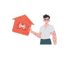 IoT concept. The guy is shown to the waist. A man holds an icon of a house in his hands. Isolated on white background. Vector illustration in flat style.