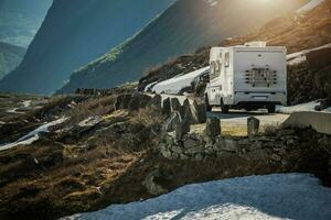 RV Camper Van on a Scenic Mountain Road Somewhere in the Norway. photo