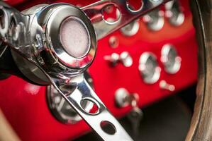 Classic Car Elegant Dashboard with Chromed Switches and Stainless Steering Wheel photo