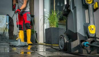 Patio Concrete Bricks Surface Cleaning Using Powerful Pressure Washer photo