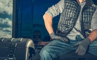 Semi Truck Driver Awaiting His Trailer To Hook Up photo