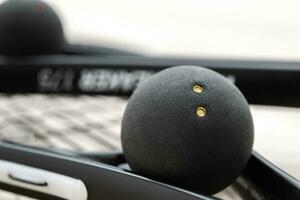 Black Ball and Squash Rockets Close Up photo