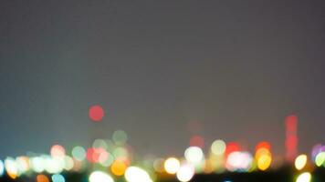 Abstact and blurred of bokeh lights shine from the buildings of the industrial estate. For background. photo