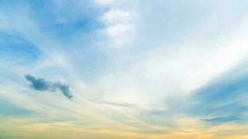 Abstract and blurred of eveing sky or morning sky. Under orange tone and on top blue color tone. With motion of white clouds. photo