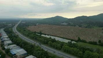 Aerial shot move over highway toward Chinese tomb at Sungai Petani, Kedah video