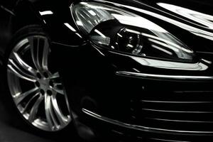 Close-up shot of a modern car headlight. Black car. AI Generative photo
