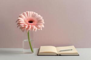 Gerbera flowers with notebook and pen. photo