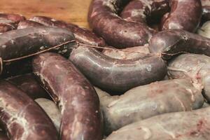 Handmade pork sausages finished on the table. photo
