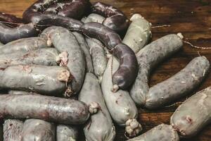 Handmade pork sausages finished on the table. photo