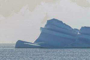 Tempano floating in the Antarctic Sea, near the Antarctic Peninsula. photo